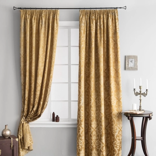 Luxurious gold window curtains with a damask pattern, hanging elegantly in a living room