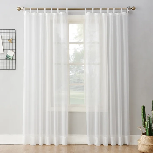 Sheer white window curtains hanging in a living room