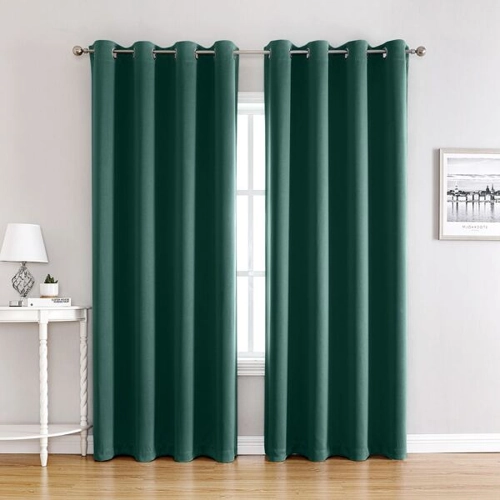 dark green blackout window curtains hanging on a metal rod in a living room